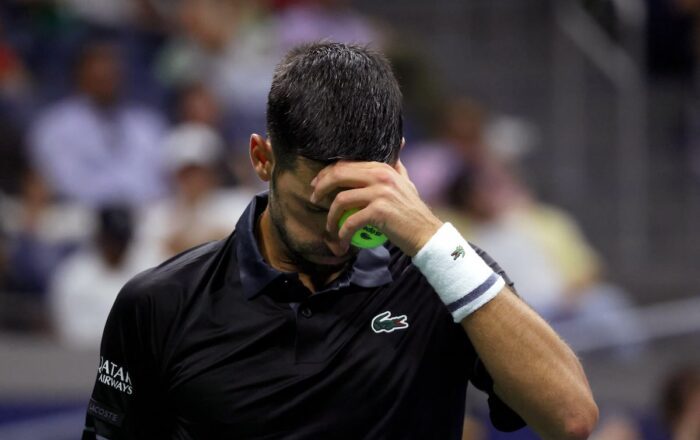 Novak Djokovic holds his head during his first-round defeat to Mariano Navone at the 2026 US Open