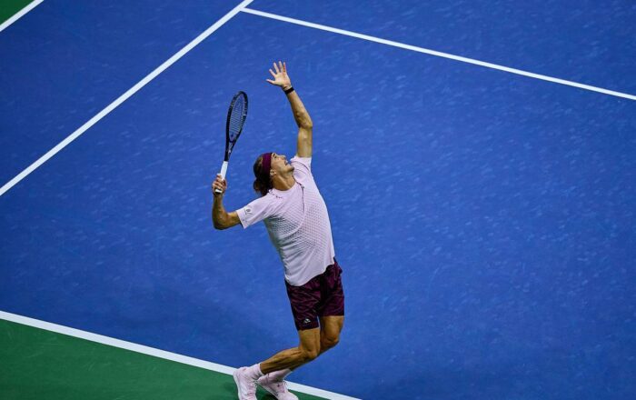 Alexander Zverev serving on a blue hard court at the 2026 US Open